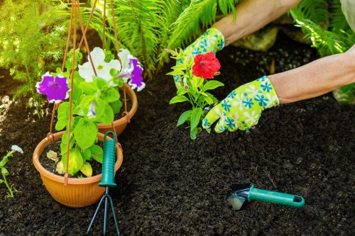 Gardeners following safe work practices during maintenance tasks